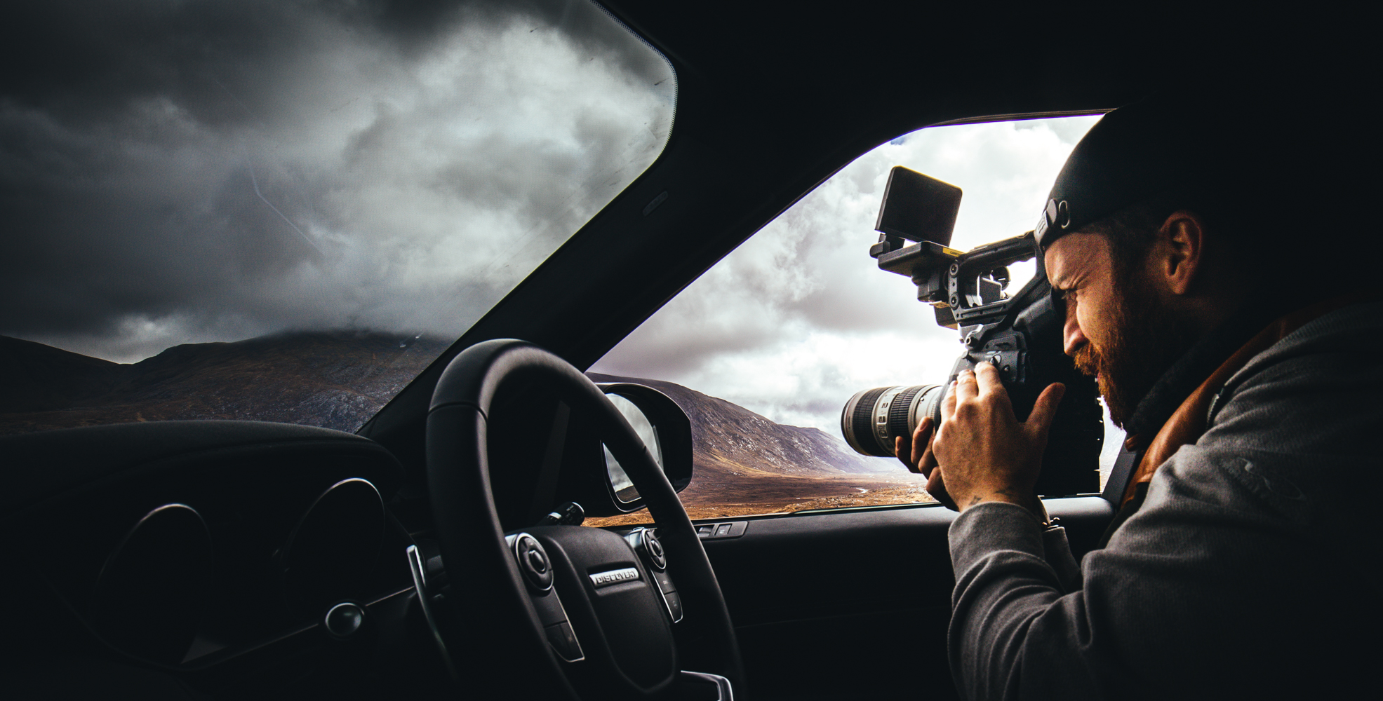 Stef filming with cinema camera from car